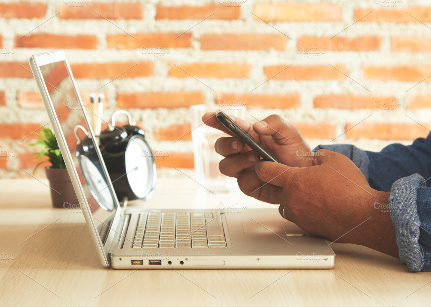 Businessman using laptop and mobile phone, a Photo by 1981 Rustic studio kan