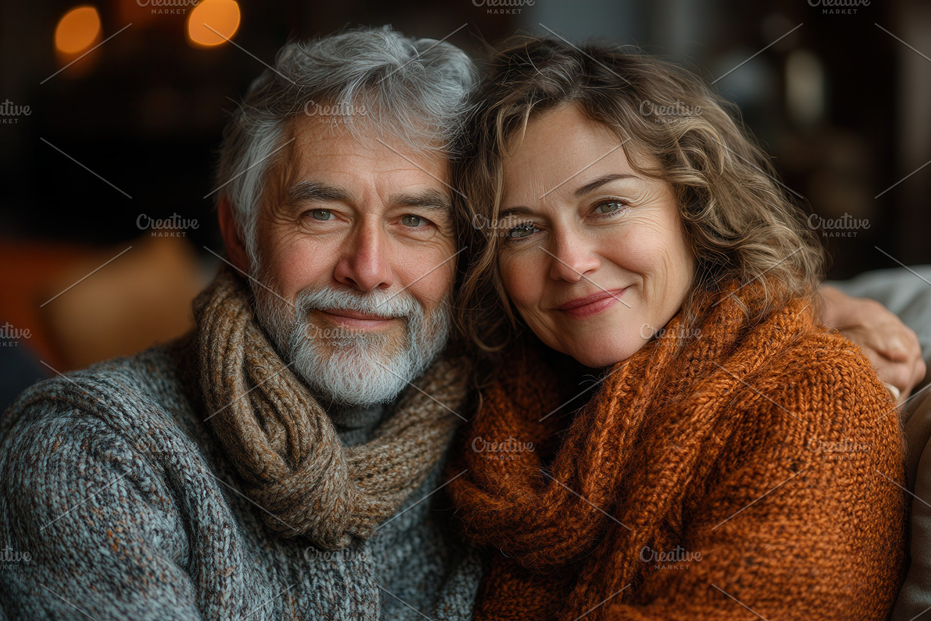 Smiling couple cozy together in warm, a Photo by Tanuart