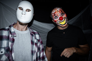 Two men wearing scary masks at Halloween party, a Holiday Photo by etorres69