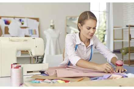 Young woman tailor work sew clothes, a Person Photo by StudioRomantic