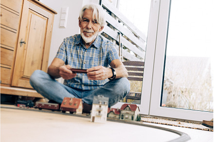 Senior Man Playing With Model Train