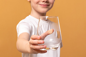 Happy young girl in white t-shirt extending an empty glass towar, a Person Photo by Ales Munt