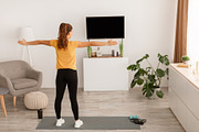 African Lady Stretching Arms To Sides Having Workout Indoor, Rear-View, a Photo by Prostock-Studio (Thumbnail 2 of 2)