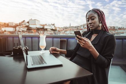 Successful black female on her phone, a Person Photo by SkyNext