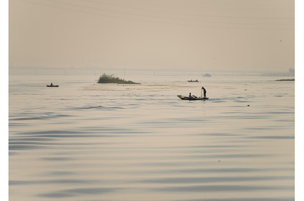 Two men in small wooden fishing boat