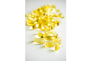 Yellow omega-3 fish oil capsules, a Health & Medical Photo by volodymyrshtun13795