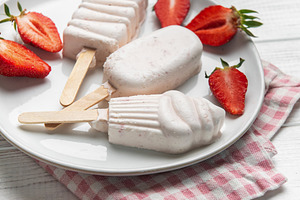 Homemade strawberry ice cream popsicles with fresh fruit, a Food & Drink Photo by Olena Rudo