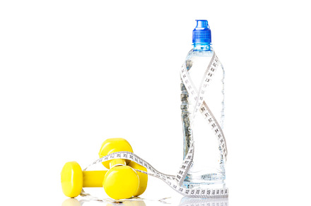 Bottle of water with measuring tape and weights.