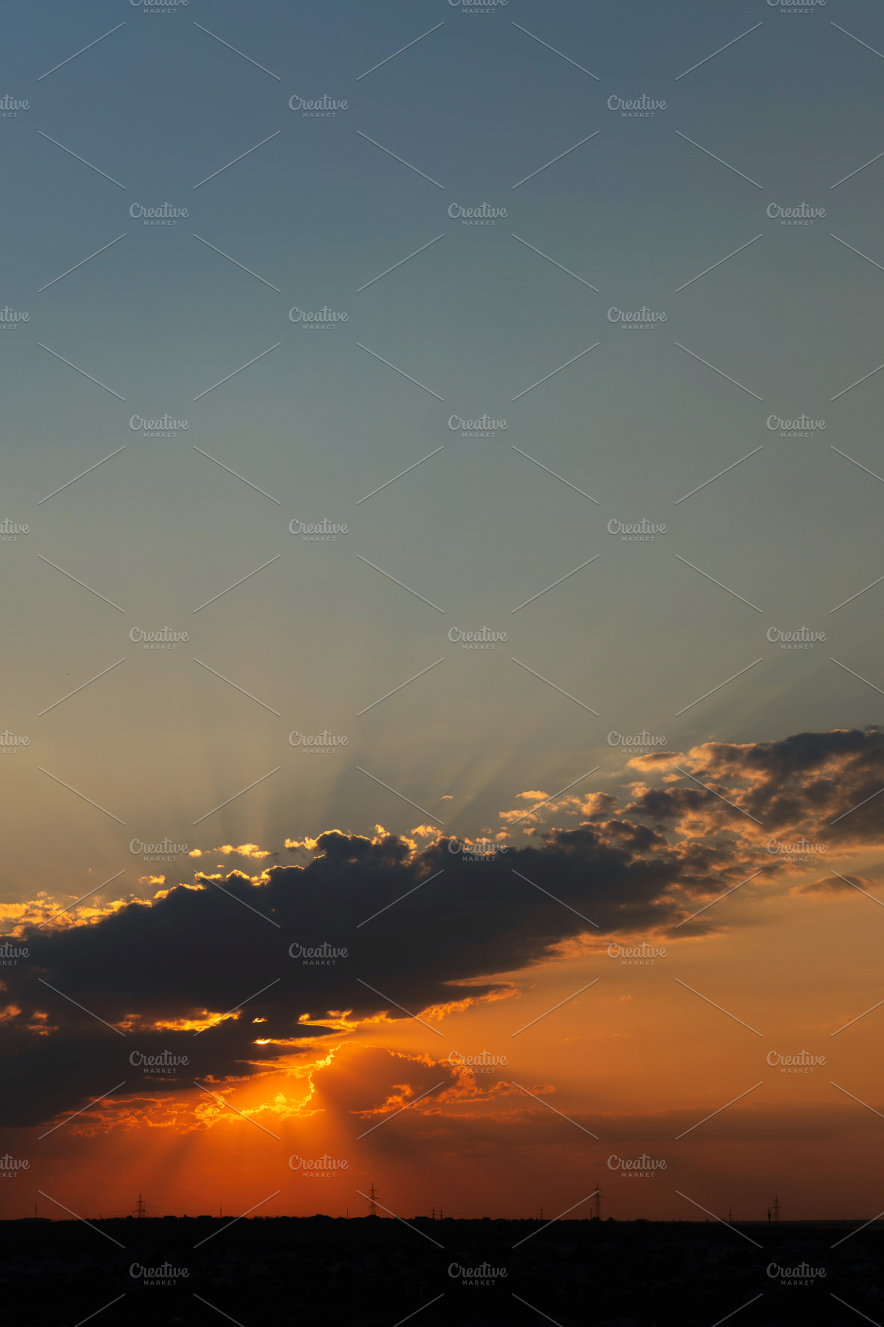 Golden sunset with sun rays shining, a Background Photo by Elena Vagengeim