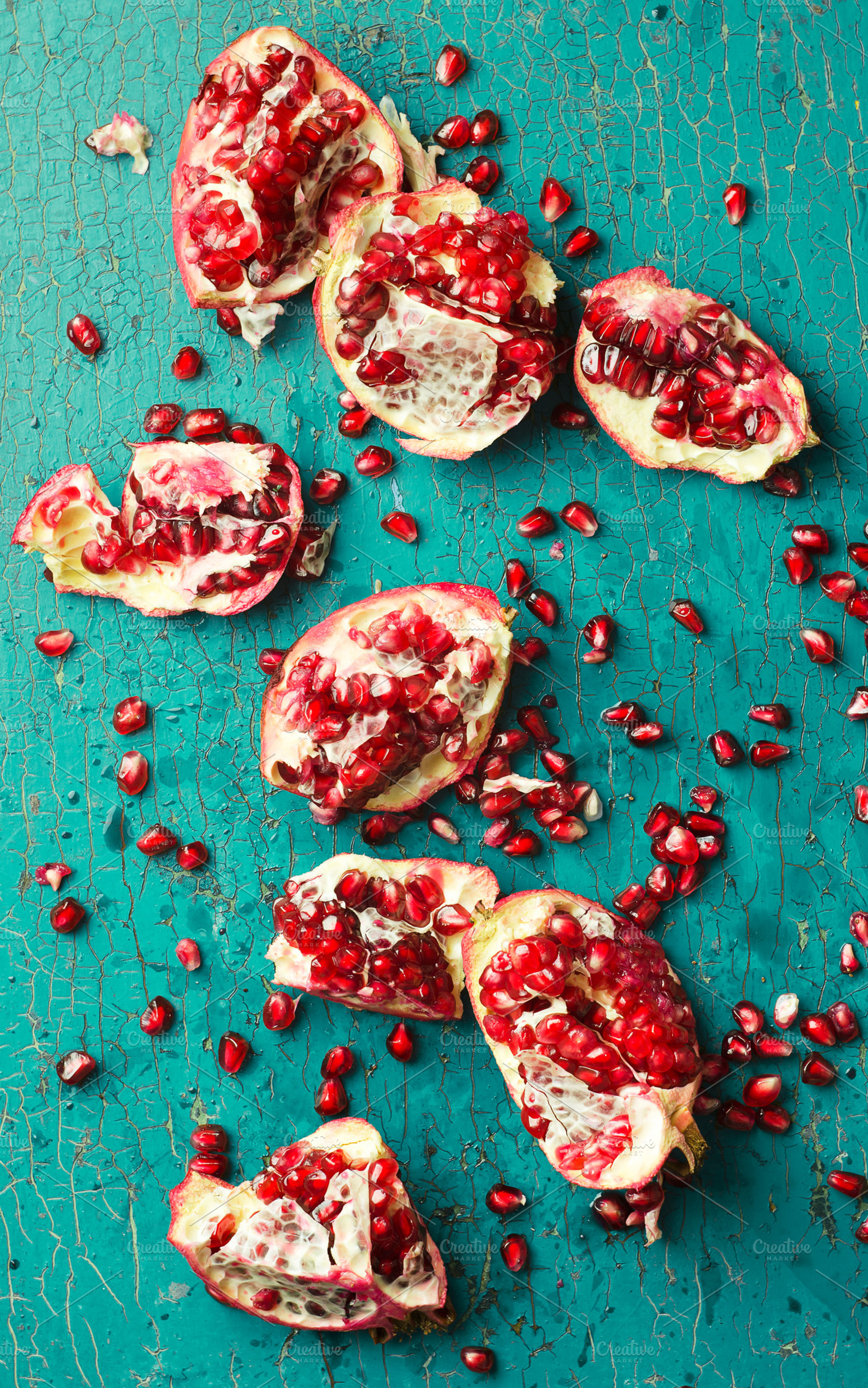 Pomegranates containing pomegranate, fruit, and red, a Food & Drink Photo by bogdandimages