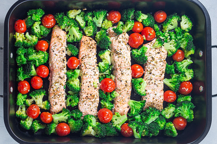 Baked salmon fillet with broccoli and tomato on frying tray, horizontal, top vi, a Food & Drink Photo by iuliia_n