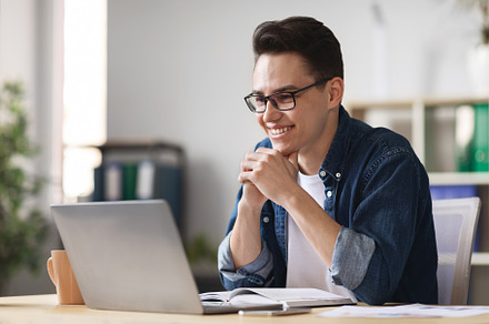 Millennial Male Entrepreneur Working With Laptop At His Desk In Office, a Photo by Prostock-Studio