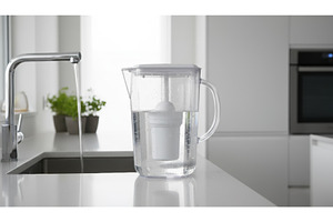 Transparent water filter jug fills, an Architecture Photo by Igor Tichonow