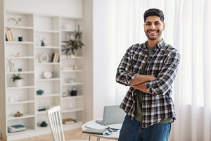 Portrait of happy man posing with folded arms, a Photo by Prostock-Studio