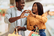 Portrait of black couple making heart shape with hands, a Photo by Prostock-Studio (Thumbnail 2 of 2)