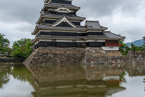 Historic Matsumoto Castle reflected in calm waters, Japan, an Architecture Photo by GoodGoods