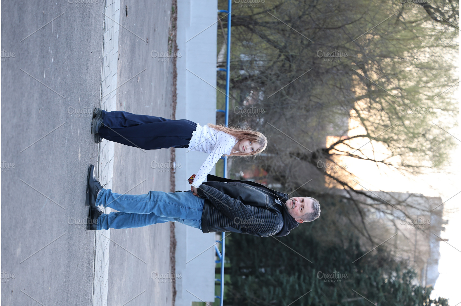 A father is walking with his, a Person Photo by Nenahliadava Design