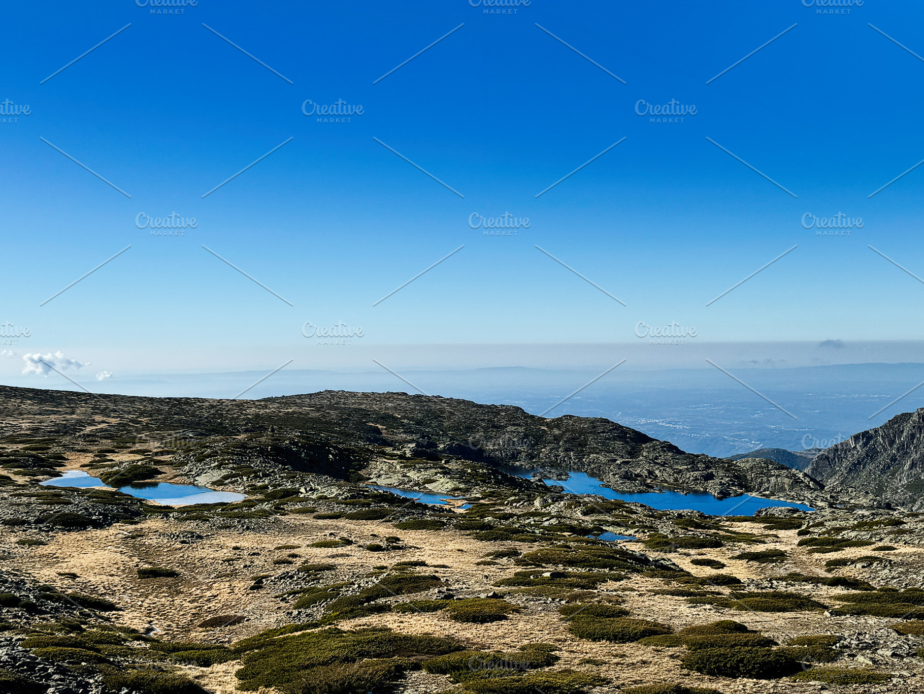 Scenic high-altitude terrain with ponds in Portugal, Serra da Estrela under cle, a Photo by AS photostudio