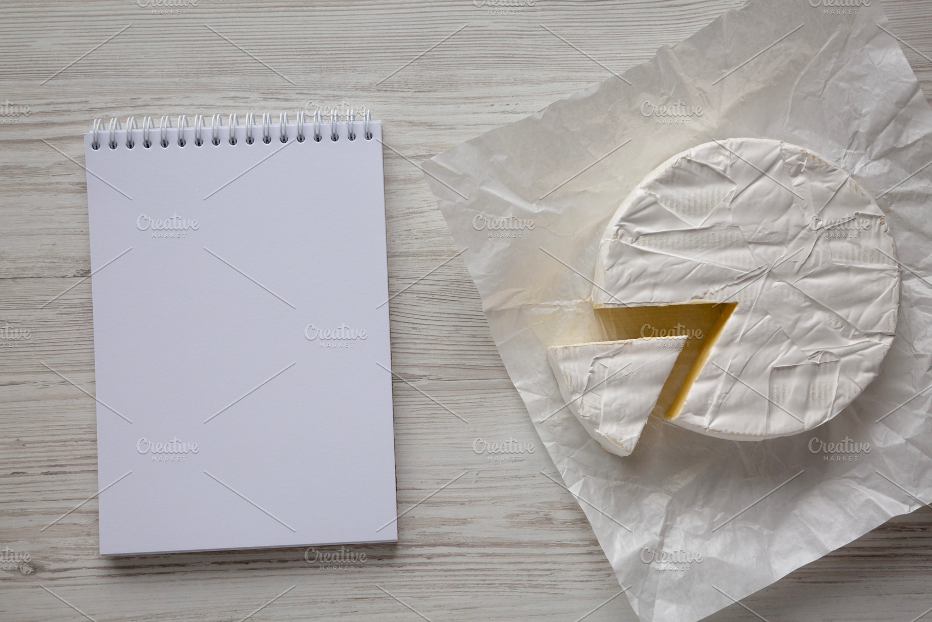 Homemade White Brie Cheese on a Wooden Board, blank notepad, top, a Food & Drink Photo by LiudmylaChuhunova