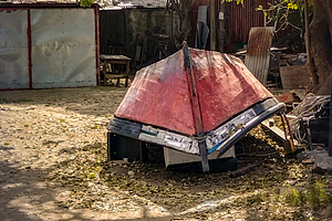 Improvised shelter with boat roof in rural yard, a Food & Drink Photo by DanFLCreativo