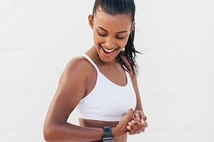 Smiling female showing her bicep, a Sports & Recreation Photo by Artem Varnitsin