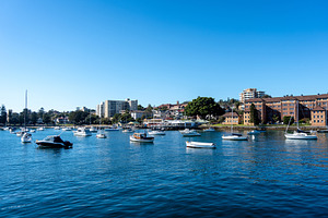 Manly Beach harbor with boats and waterfront buildings in Sydney, an Architecture Photo by GoodGoods