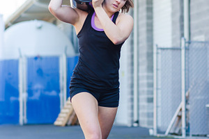 Crossfit barrel carry  young woman stock photo containing crossfit and fitness