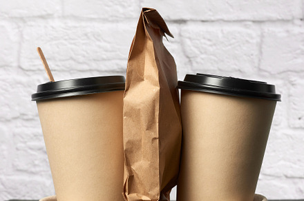 Two brown paper disposable cups with containing bag, americano, and beverage, a Food & Drink Photo by ndanko