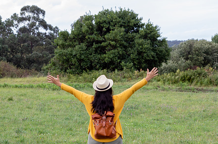 Adult woman with a leather backpack walks down, a Person Photo by José Manuel Gelpi