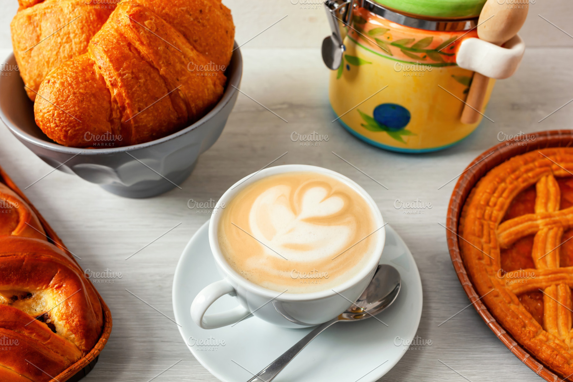 Delicious italian breakfast with cappuccino, croissants and crostata tart on a, a Food & Drink Photo by Antonio Gravante Market