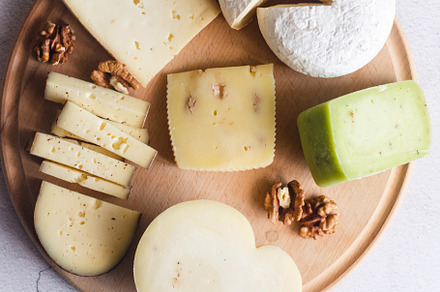 Delicious cheese mix with grapes, jam, snacks, crackers, walnuts, a Food & Drink Photo by vimart