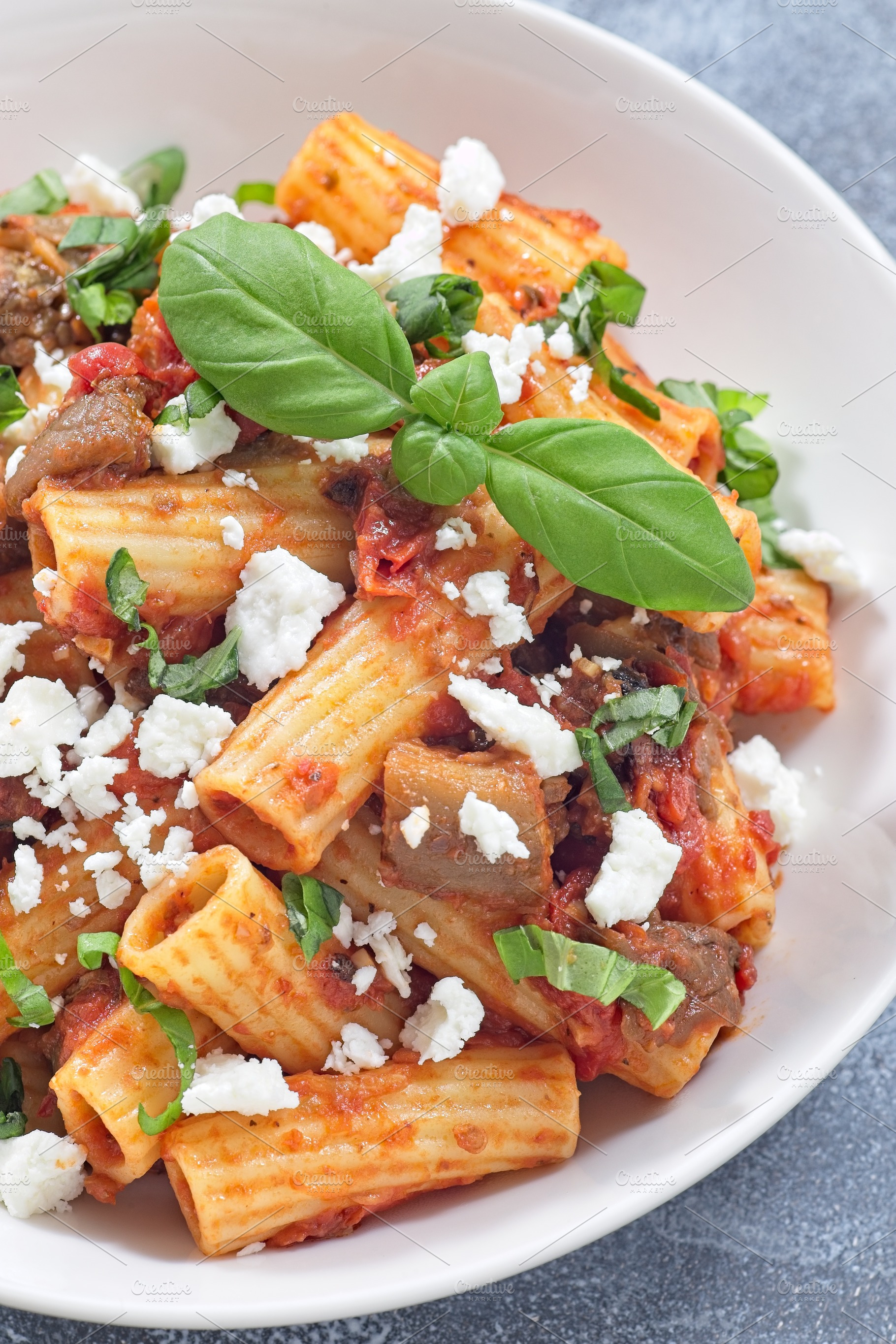 Rigatoni alla Norma pasta with eggplant and tomato, basil and ricotta salata, v, a Food & Drink Photo by iuliia_n