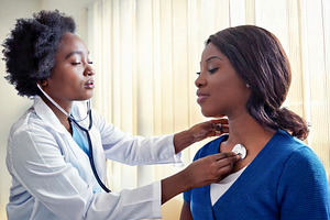 Patient being examined by a doctor using a stethoscope, a Health & Medical Photo by DanFLCreativo