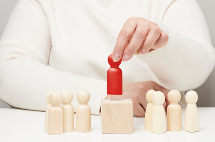 the woman keeps the red wooden figurine separate from the group., a Photo by ndanko