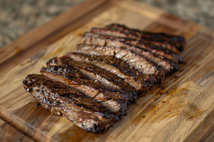 Marinated flank steak resting on a w, a Photo by Iftikhar Alam
