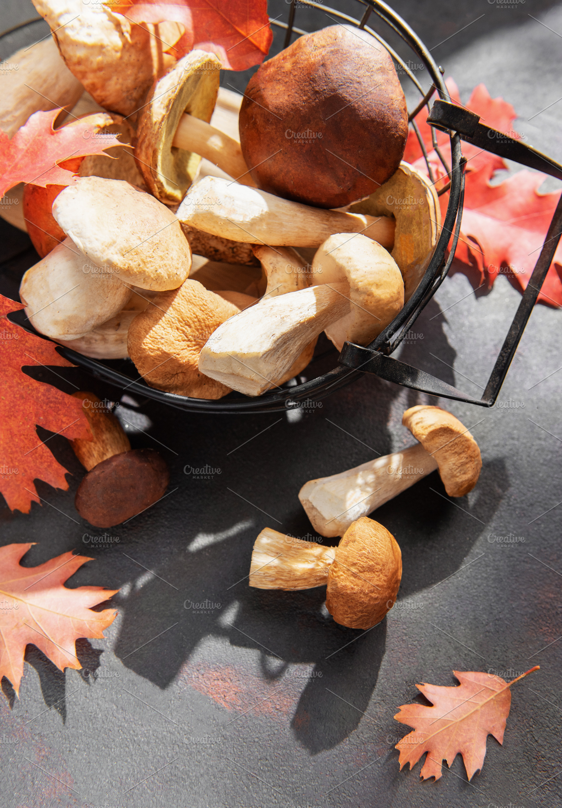 Porcini mushrooms in basket with autumn leaves, a Food & Drink Photo by Olena Rudo