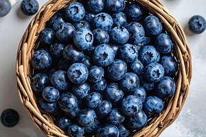 Fresh blueberries in wicker basket viewed from above, a Food & Drink Photo by GoodGoods