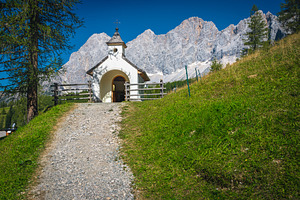 Small alpine chapel in the mountains, an Architecture Photo by Alpine Dreams