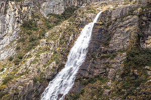 Waterfall cascading from snowy mountains on the Laguna 69 trek,, a Nature Photo by GoodGoods