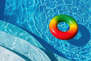 Colorful Inflatable Ring Floating in Clear Blue Pool, a Sports & Recreation Photo by Davizro's Market