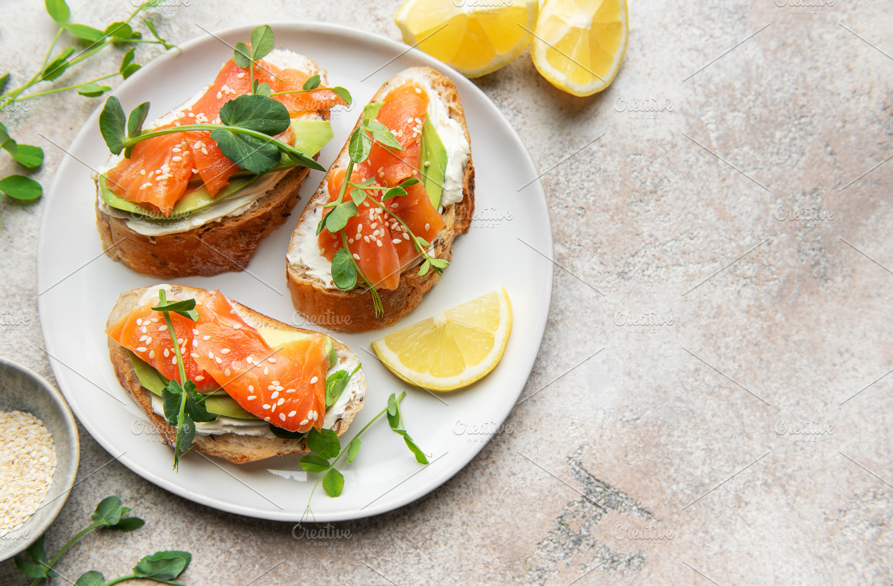 Smoked salmon avocado toast with seeds and sprouts, a Food & Drink Photo by Olena Rudo