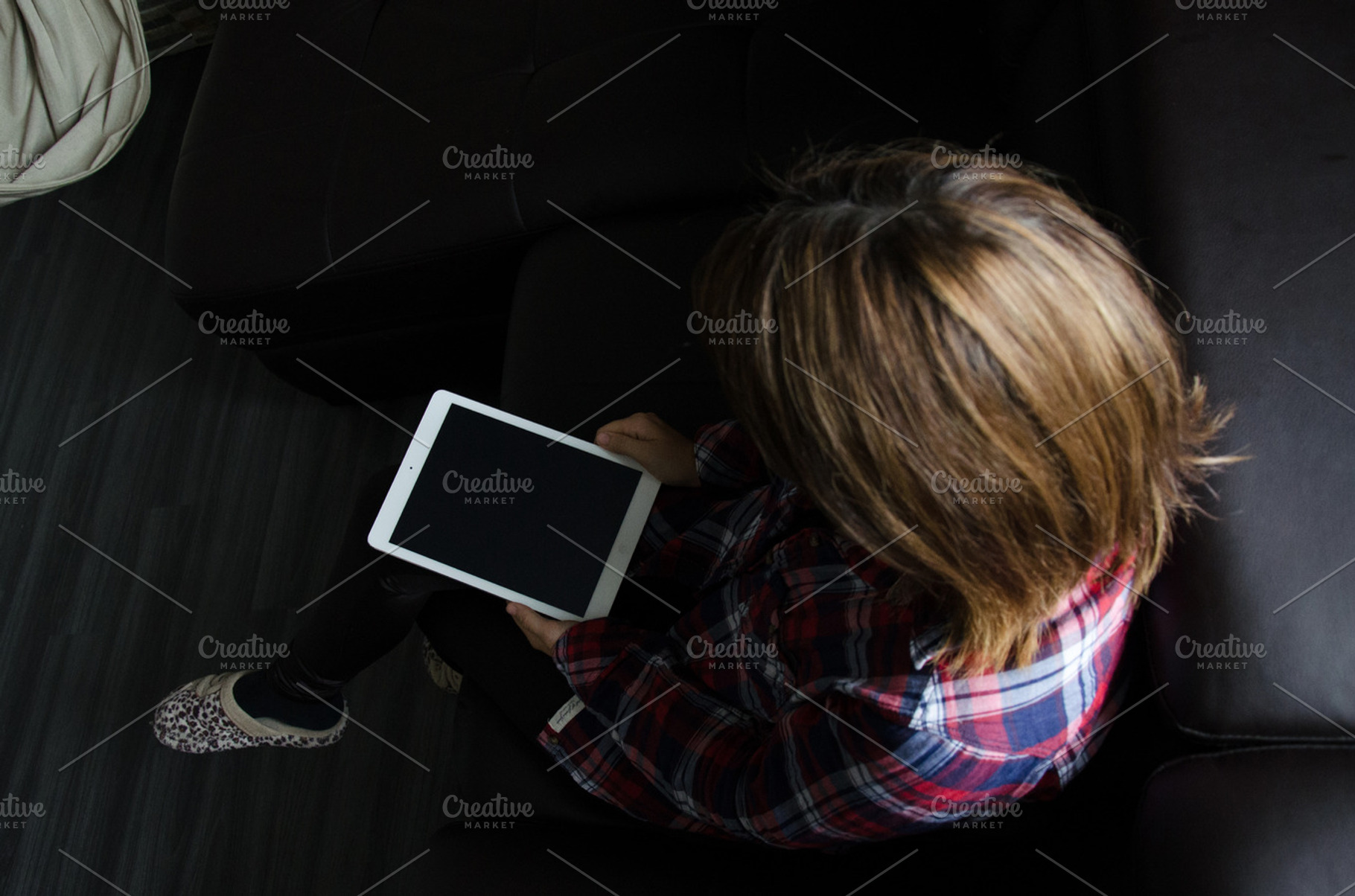 Hipster holding a white ipad containing mac, macbook, and laptop