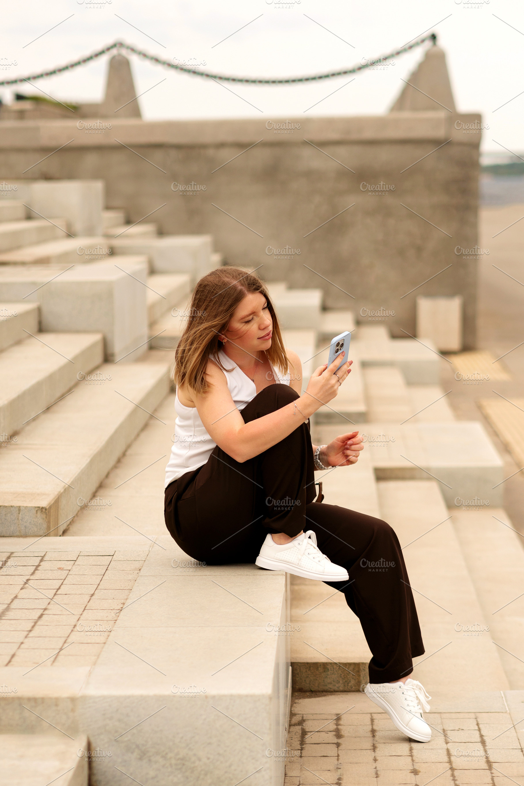 Young woman sitting on steps, a Person Photo by Elena Vagengeim