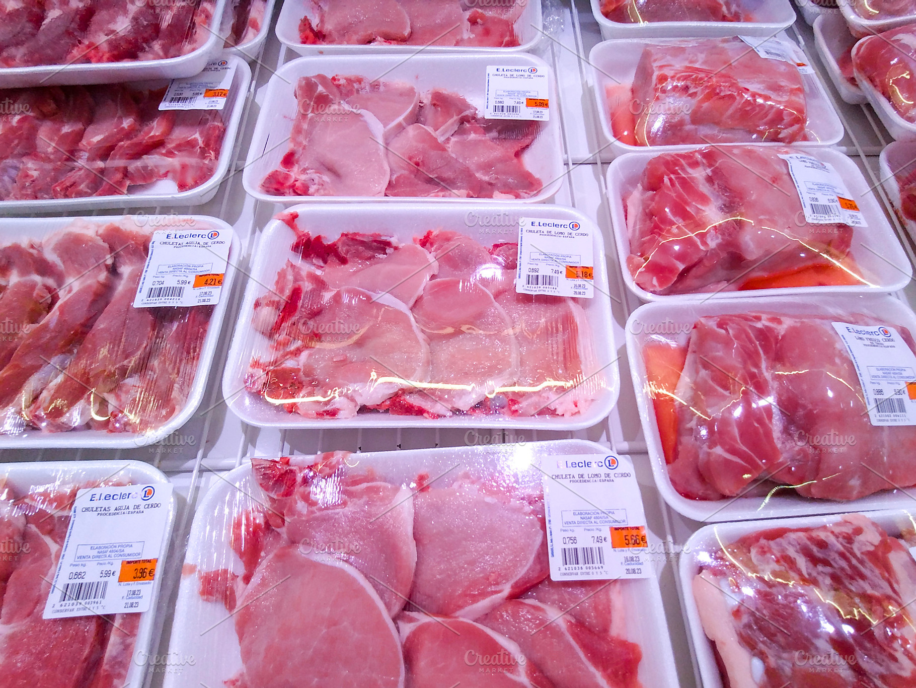 Packaged raw pork meat in supermarket refrigerator, a Food & Drink Photo by DanFLCreativo