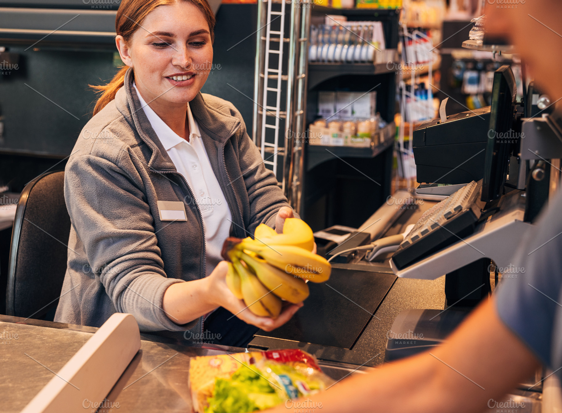 Cheerful female working as a cashier, a Person Photo by Artem Varnitsin