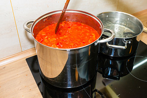 Cooking tomato sauce in big cooking pot, a Food & Drink Photo by Vapi