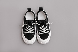 Child's black sneakers, a Beauty & Fashion Photo by Kolomiyets Viktoriya