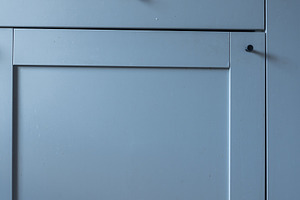 Minimalist kitchen cabinet door with a smooth blue surface and s, an Industrial Photo by MDBildes