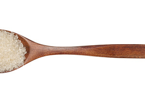 Cane white sugar in a brown wooden spoon on an isolated backgrou, a Food & Drink Photo by ndanko