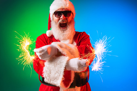 Close-up Happy stylish Santa Claus having fun with bright sparklers, awaiting f, a Person Photo by Volodymyr Melnyk